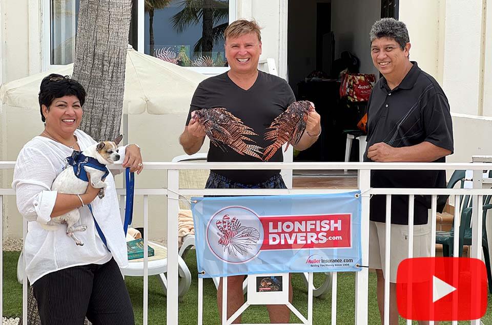 Esmerelda Kock with her husband and Roger J. Muller, Jr. holding 2 lionfish